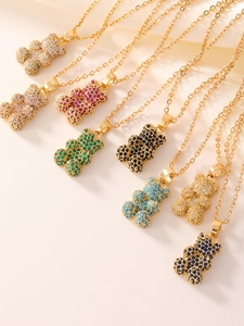 Detail of colorful teddy bear pendants with heart-shaped cubic zirconia on gold chains