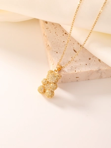 Macro shot of gold bear pendant encrusted with sparkling cubic zirconia on link chain