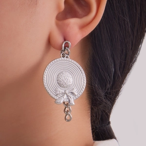 Silver stainless steel straw hat earrings with bow and chain detail on model