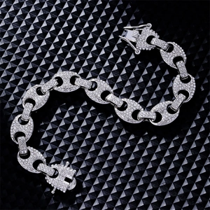 Close-up of silver-tone hip-hop style link bracelet with pave rhinestones on black base