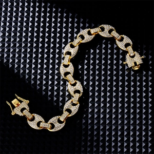 Close-up of golden iced-out mariner link chain bracelet with white rhinestones