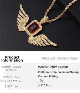Detailed view of hip hop gold angel wings pendant with large red zircon and white crystals