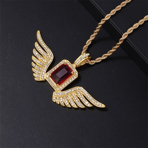 Close-up of hip hop wing pendant with red gemstone and white rhinestones on gold rope chain