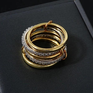 Modern gold and silver stacked ring set featuring micro-pave stones on textured bands