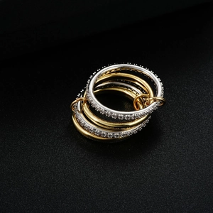 Minimalist interlocking mixed-tone gold and silver stacking rings with pavé crystal detail