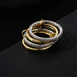 Stacked two-tone hip hop rings with gold and silver bands and micro-pave crystals