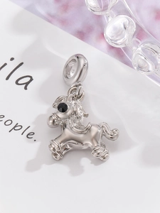 Macro shot of silver horse charm with black gemstone eye for DIY necklace bracelets