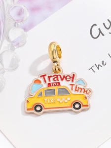 Macro view of a yellow enamel taxi pendant with Travel Time engraving for charm bracelets