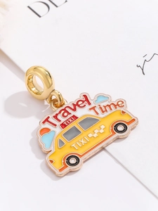 Detail of yellow taxi enamel charm with golden loop and Travel Time engraving