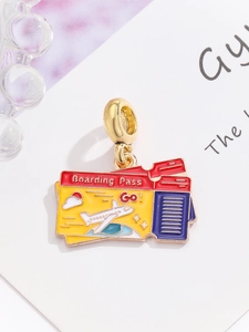 Detailed macro view of gold boarding pass charms with colorful enamel for DIY jewelry