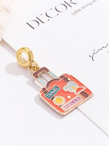 Detail of travel suitcase charm with colorful enamel patterns for DIY jewelry making