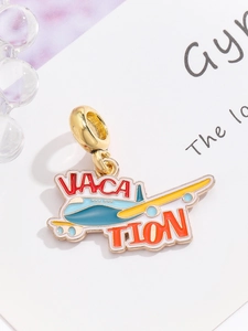 Detailed close-up of a gold vacation airplane charm with blue and yellow enamel finish