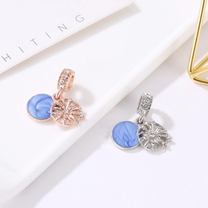 Detail of blue enamel snowflake charm with pave cubic zirconia in silver and rose gold