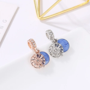 Elegant snowflake sunburst charms in rose gold and silver with blue marble enamel