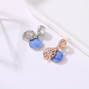 Elegant blue snowflake charm pendant with sparkling crystals in silver and rose gold finish