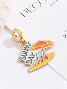 Detail of sunny day beach enamel charm with golden metal frame for DIY jewelry