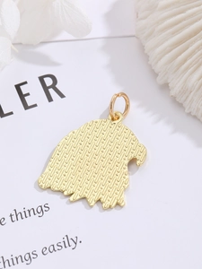 Detailed view of a golden eagle head pendant with textured finish for DIY jewelry making