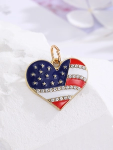 Macro detail of heart-shaped USA flag pendant with crystals on gold plated base