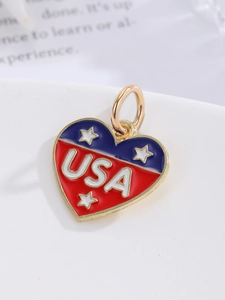 Macro shot of heart-shaped USA flag pendant with red white blue enamel and gold loop