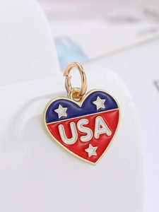 Macro shot of heart-shaped USA flag charm with red blue white enamel and golden plating