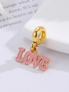 Nahaufnahme von rosa Emaille-Anhänger LOVE mit goldenem Metallrahmen für Schmuck