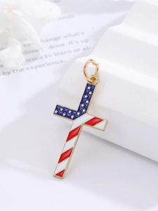 Detailed macro view of American flag cross pendant with red stripes and blue stars