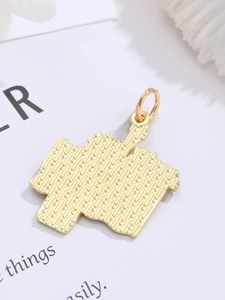 Detail of the golden pendant back showing intricate grid texture and durable metal ring