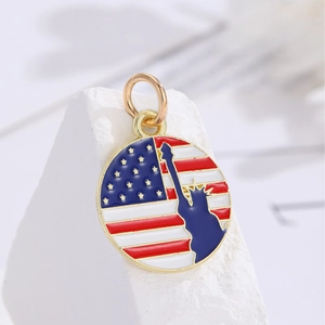 Round American flag charm featuring Statue of Liberty silhouette with gold trim edges