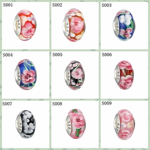 Detailed grid of assorted glass beads with floral patterns and 925 silver core for DIY jewelry