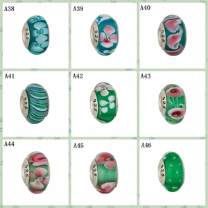 Detailed grid of glass clover charms with S925 silver cores for DIY jewelry making