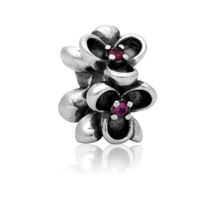 Detailed macro of vintage silver flower charm with purple crystals for DIY jewelry