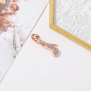 Close-up of rose gold high heel pendant with white crystals for necklaces and bracelets