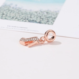 Detailed view of rose gold high heel charm pendant with sparkling crystal inlay