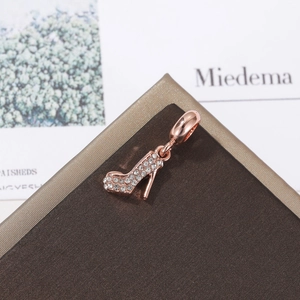 Macro shot of rose gold high heel pendant with sparkling crystals on jewelry display