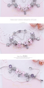 Detail of pink crystal beads and flower charms on a silver-plated snake chain bracelet