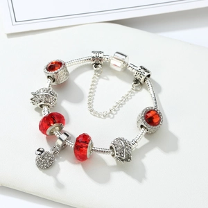 Detailed macro of 925 silver charm bracelet with pink crystals and floral pendants