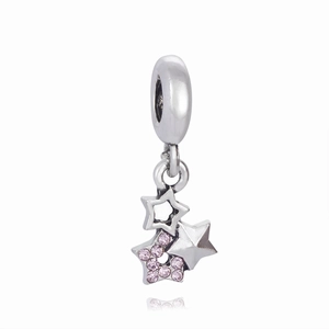 Close-up of three-layered star charm with pink crystals for DIY braided red rope bracelets