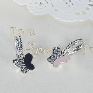 Macro detail of enamel butterfly charms with pavé cubic zirconia for DIY jewelry