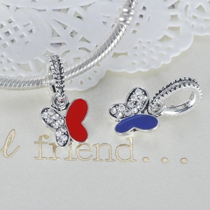 Detailed macro view of colorful butterfly charms with zircons on a silver snake chain