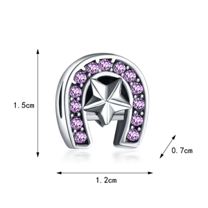 Macro detail of horseshoe charm with purple zircon stars, size 1.5cm by 1.2cm