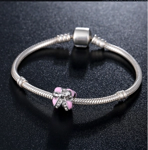 Silver snake chain bracelet featuring a pink enamel gift box charm with crystal bow