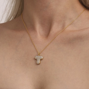 Luxury gold letter T pendant necklace with sparkling zircons on a delicate chain