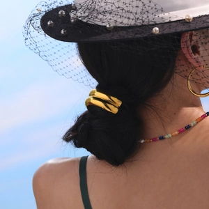Polished 18K gold plated stainless steel ponytail hair cuff on female low bun