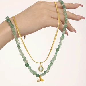 Double layered necklace with green strawberry natural stones, fishtail pendant and snake chain
