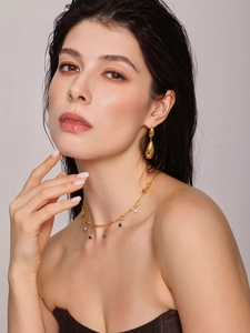 Détail du collier de perles d'eau douce et boucles d'oreilles dorées sur mannequin