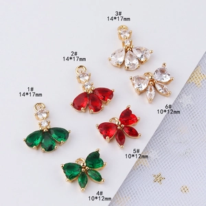 Colgantes de lazo y falda chapados en oro con circonitas de colores para joyería