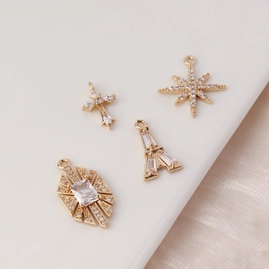 Golden plated copper pendants with zircon featuring Eiffel Tower, star, and cross motifs