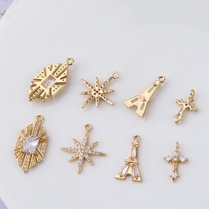Detail of gold-plated Eiffel Tower and star pendants with micro-pave zircon crystals