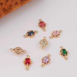 Detail of vintage gold-plated rectangular zircon charms with dual loops for DIY jewelry
