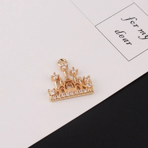 Detailed view of a gold-plated crown pendant with cubic zirconia for jewelry making